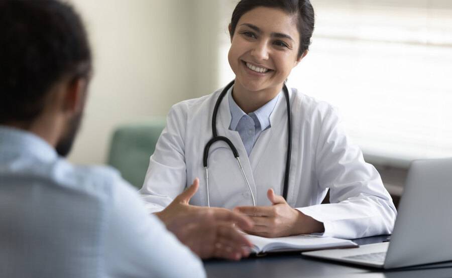 A cancer specialist meets with a patient to discuss the screenings available for detecting cancer.