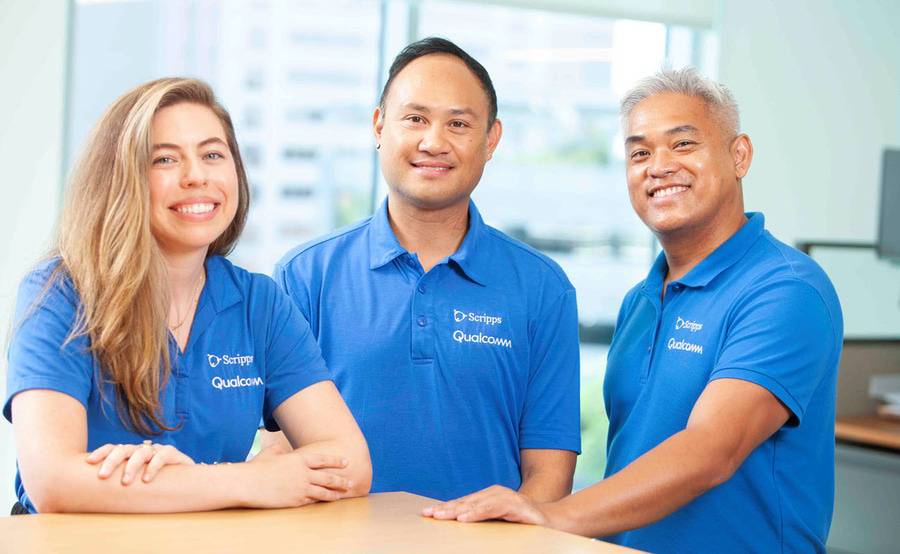 Qualcomm Concierge team members smile for a photo at the home office.