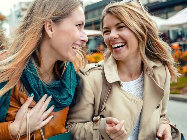 Two women shopping together and laughing